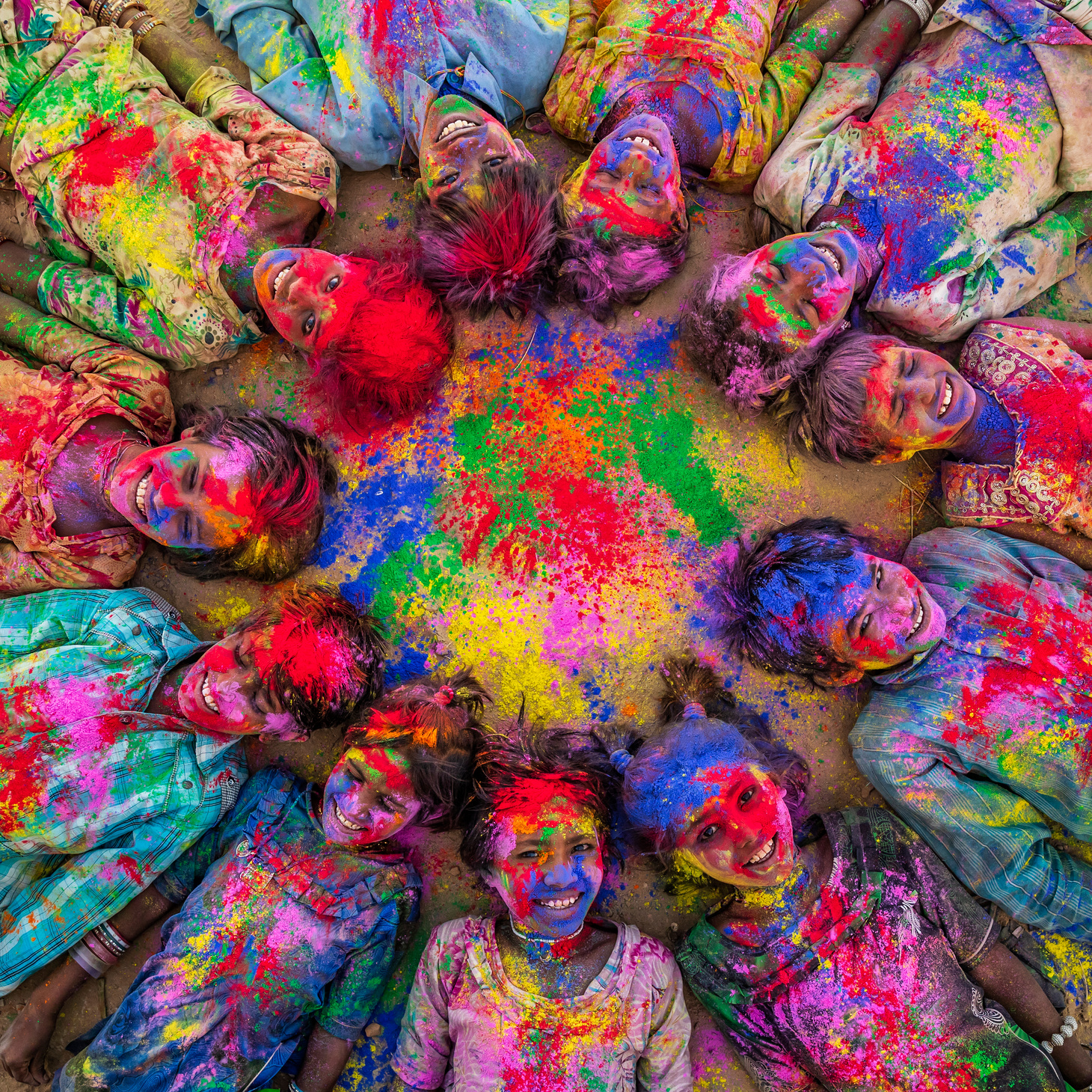 Group of happy Indian children playing holi, desert village, India